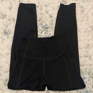 Girlfriend Collective cropped black leggings with side pockets.